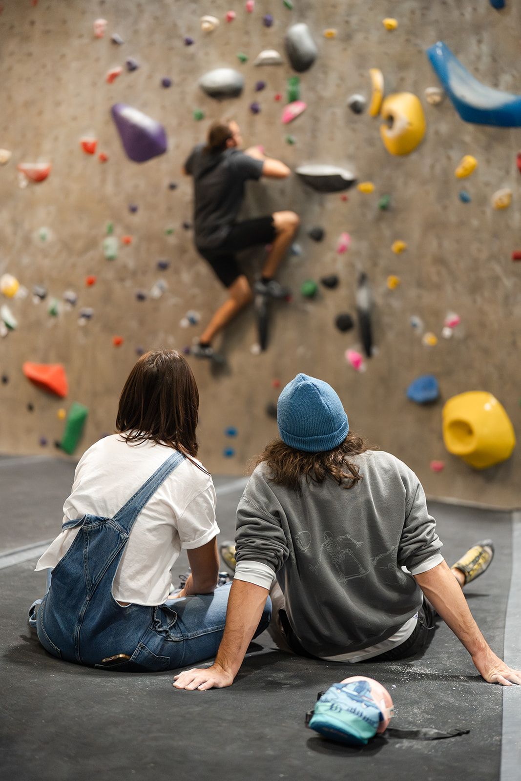 Two people watching a person climb