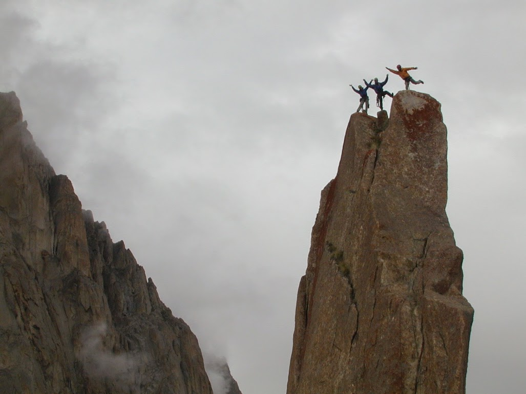 Steph Davis, David Anderson and Jimmy Chin do a summit dance after making the first ascent of Tahir Tower, Kondus Valley, Pakistan. (2000)