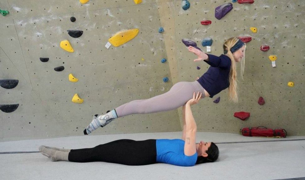 Person helps with climbing harness 