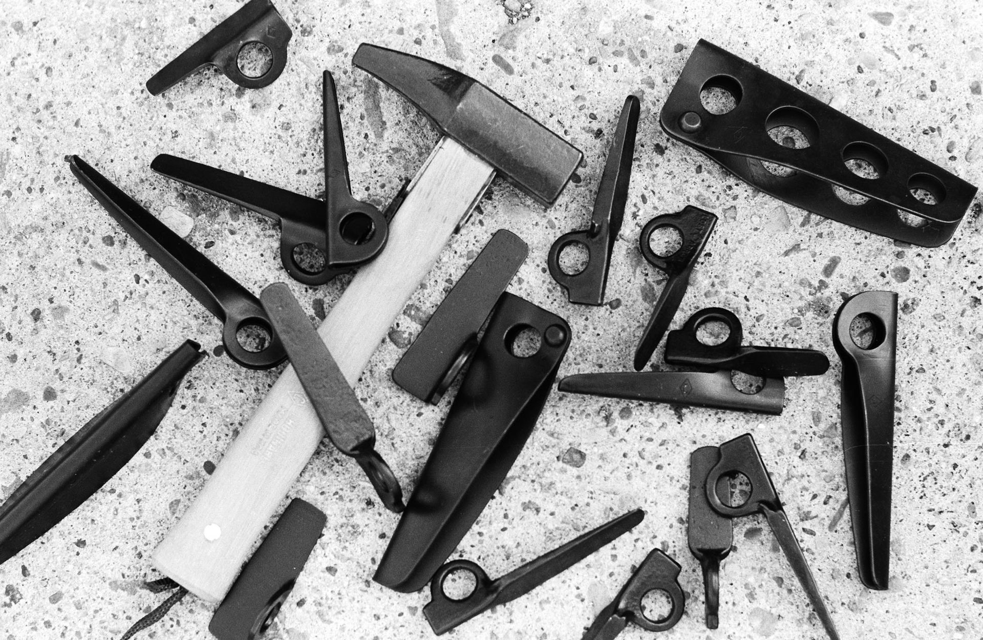 Climbing gear including rock protection devices and a hammer