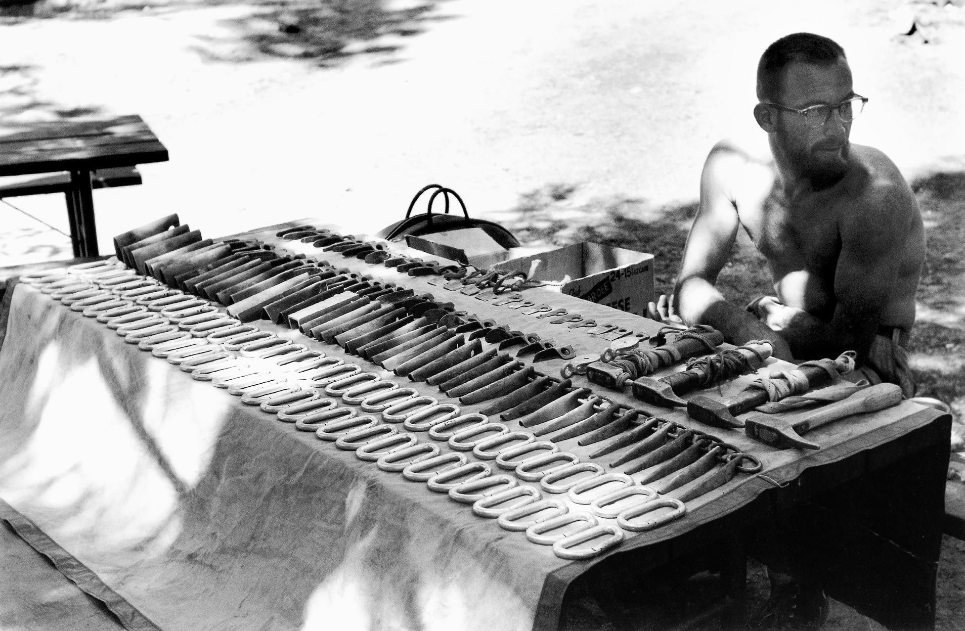 Man at a table displaying things