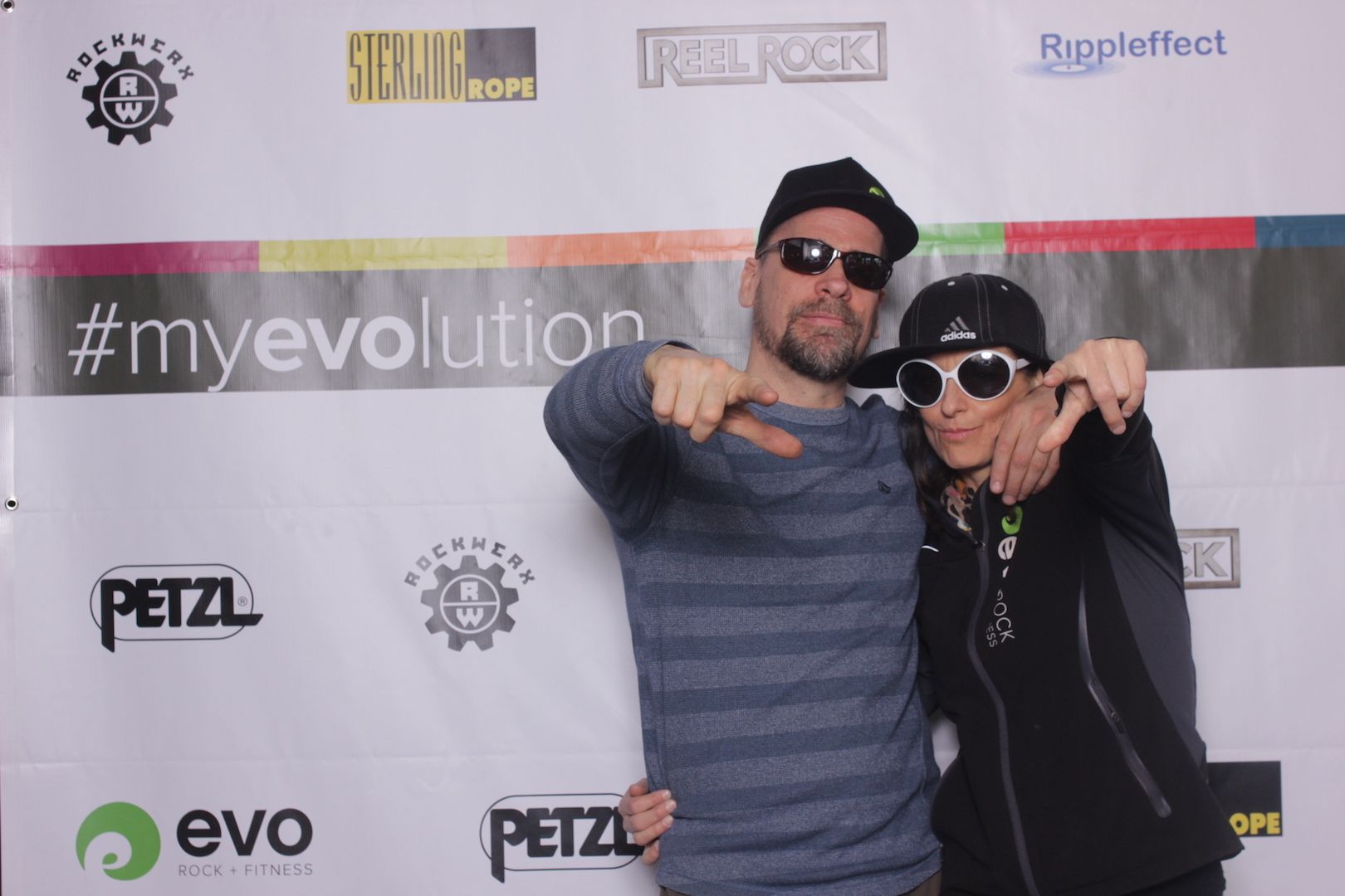 posing in front of a branded backdrop 2