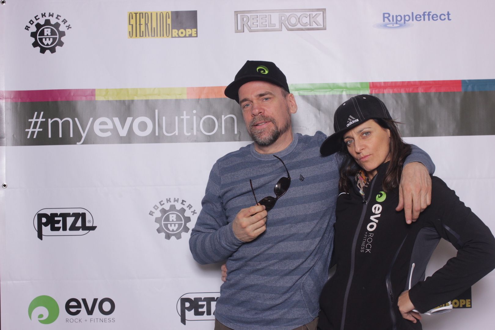 posing in front of a branded backdrop 3