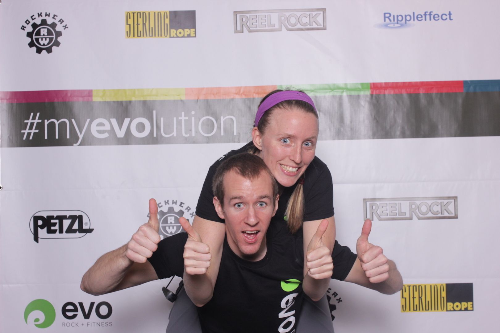 posing in front of a branded backdrop 8