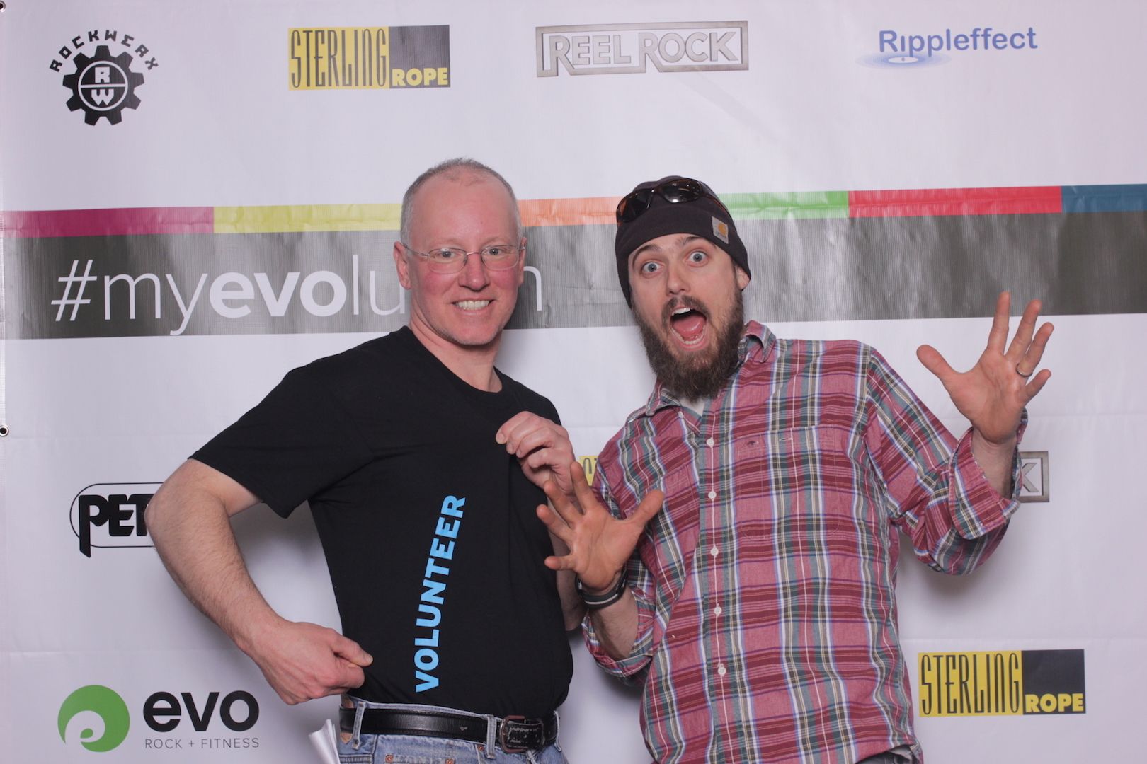 posing in front of a branded backdrop 9