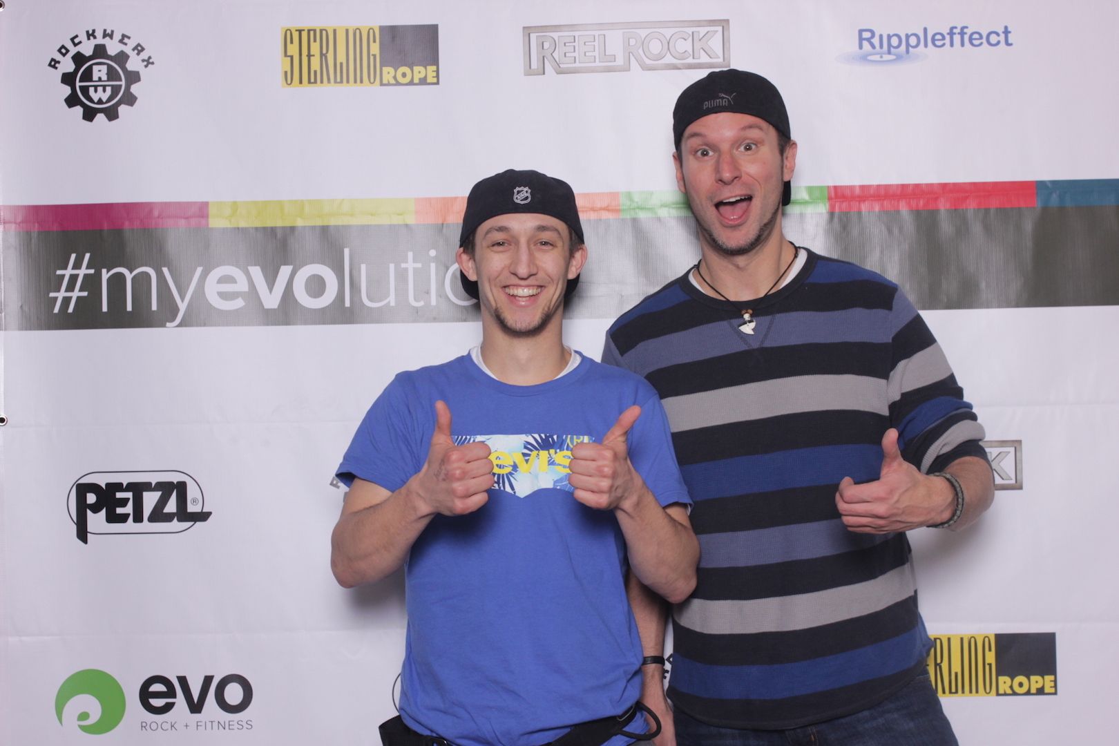 posing in front of a branded backdrop 10