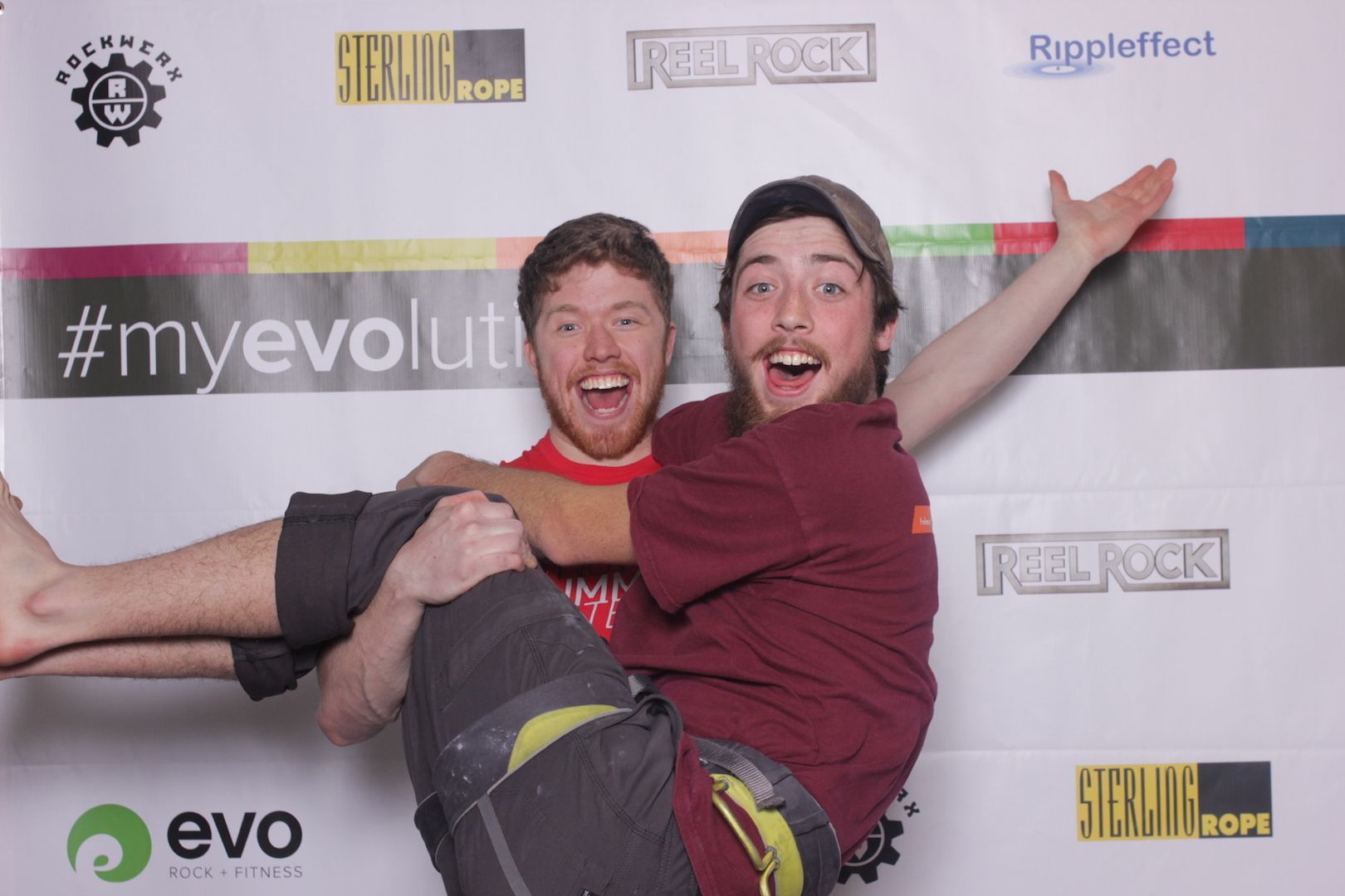 posing in front of a branded backdrop 12