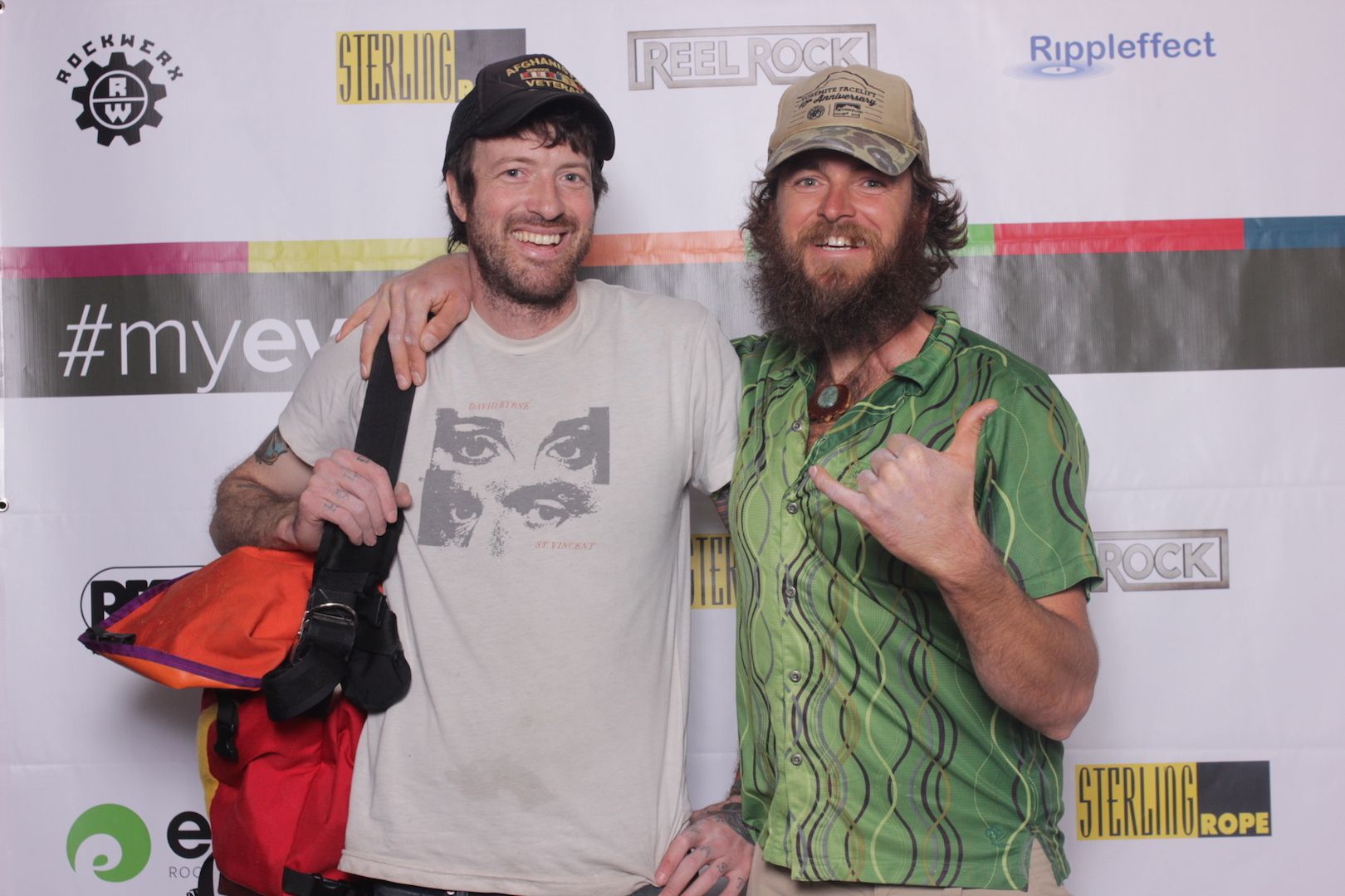 posing in front of a branded backdrop 13