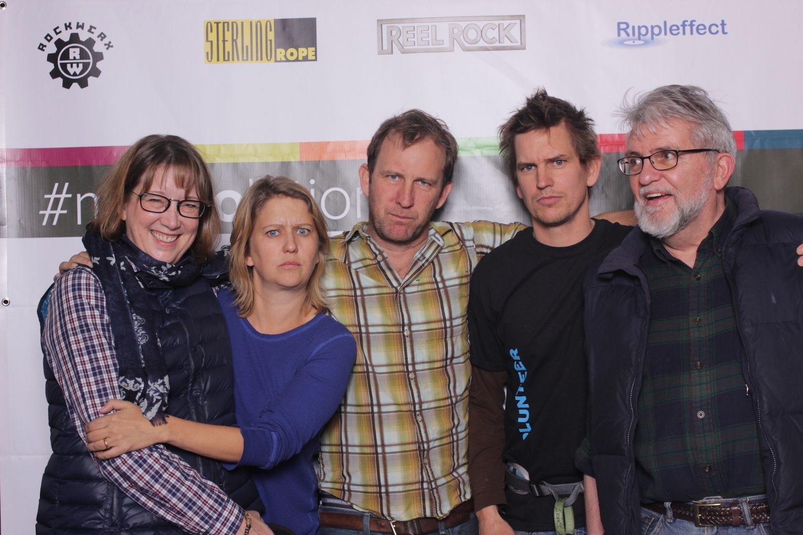 posing in front of a branded backdrop 14