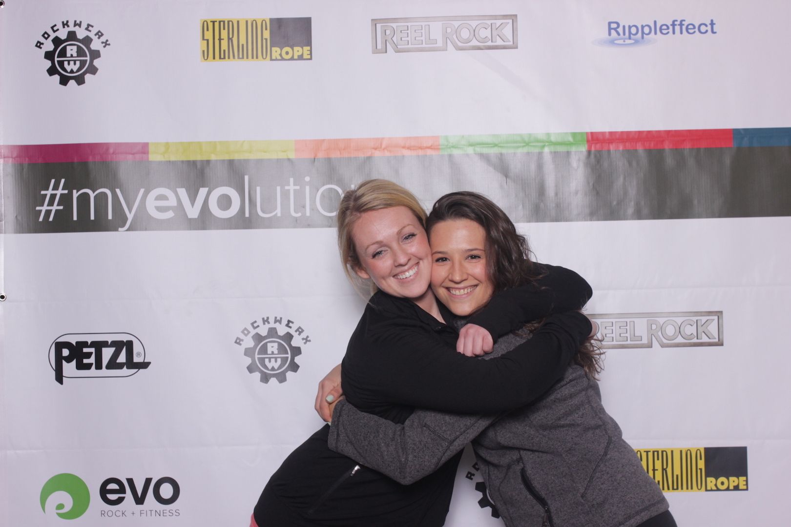 posing in front of a branded backdrop 15