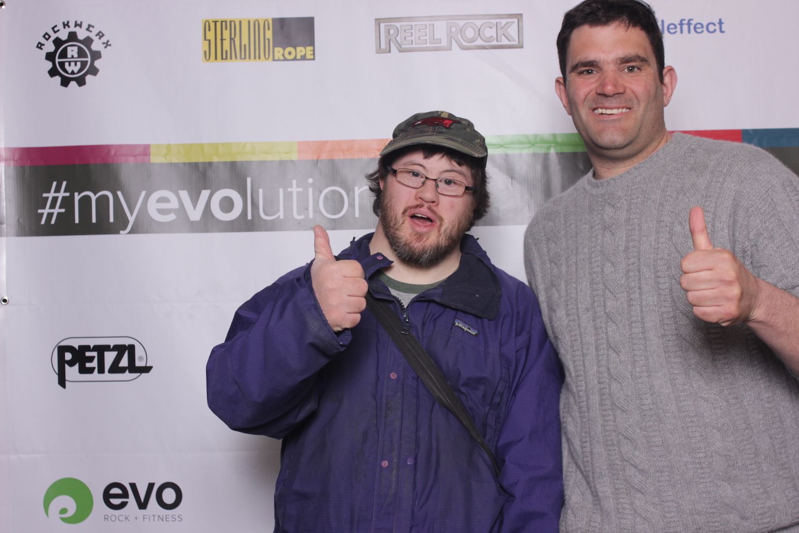 posing in front of a branded backdrop 16