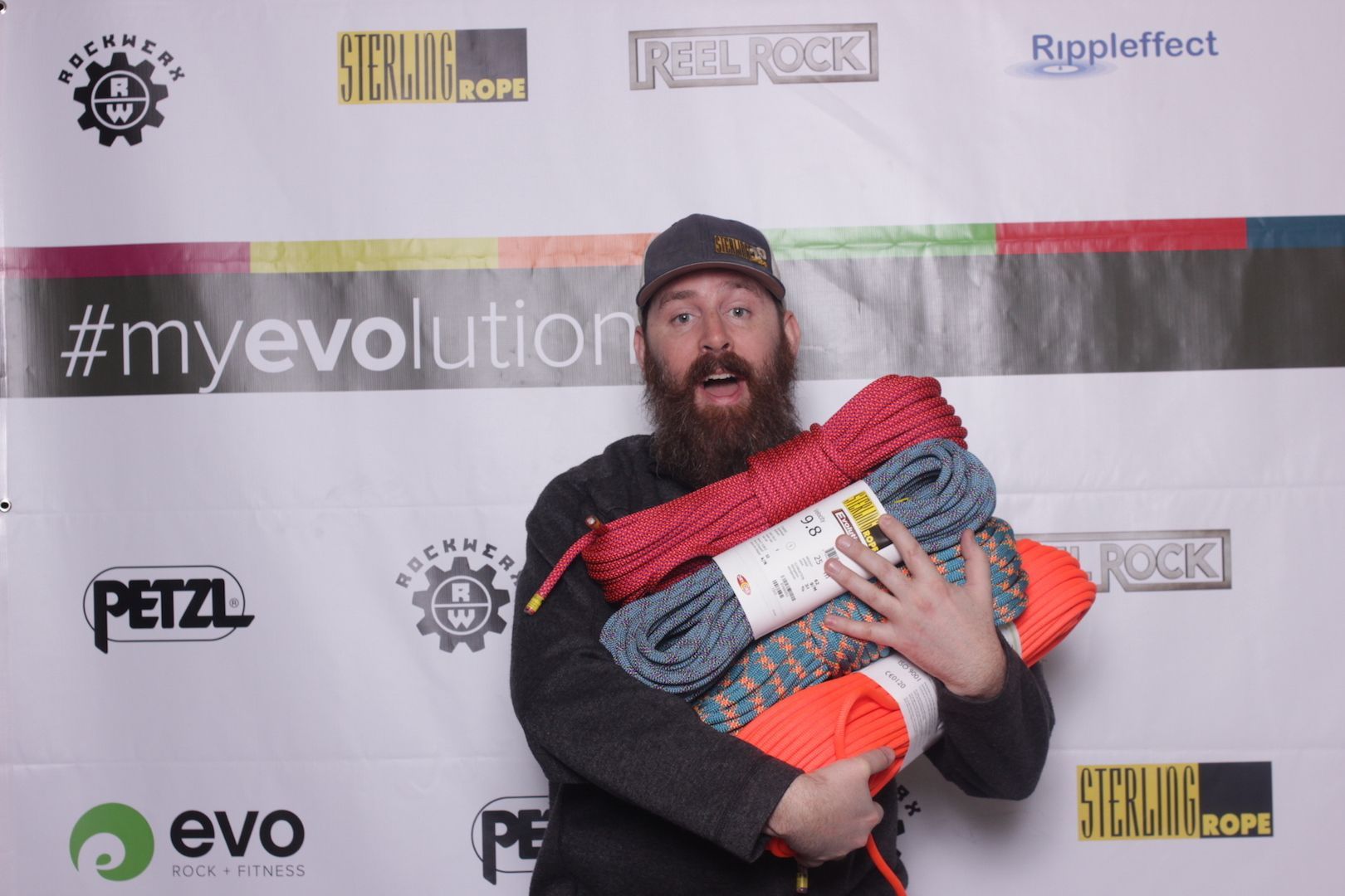 posing in front of a branded backdrop 17