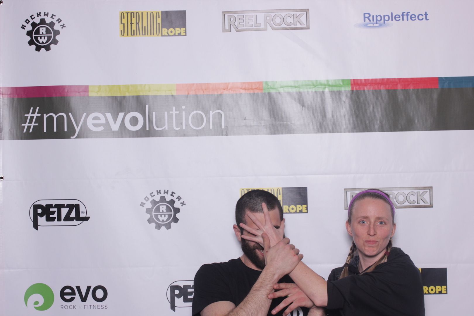 posing in front of a branded backdrop 18