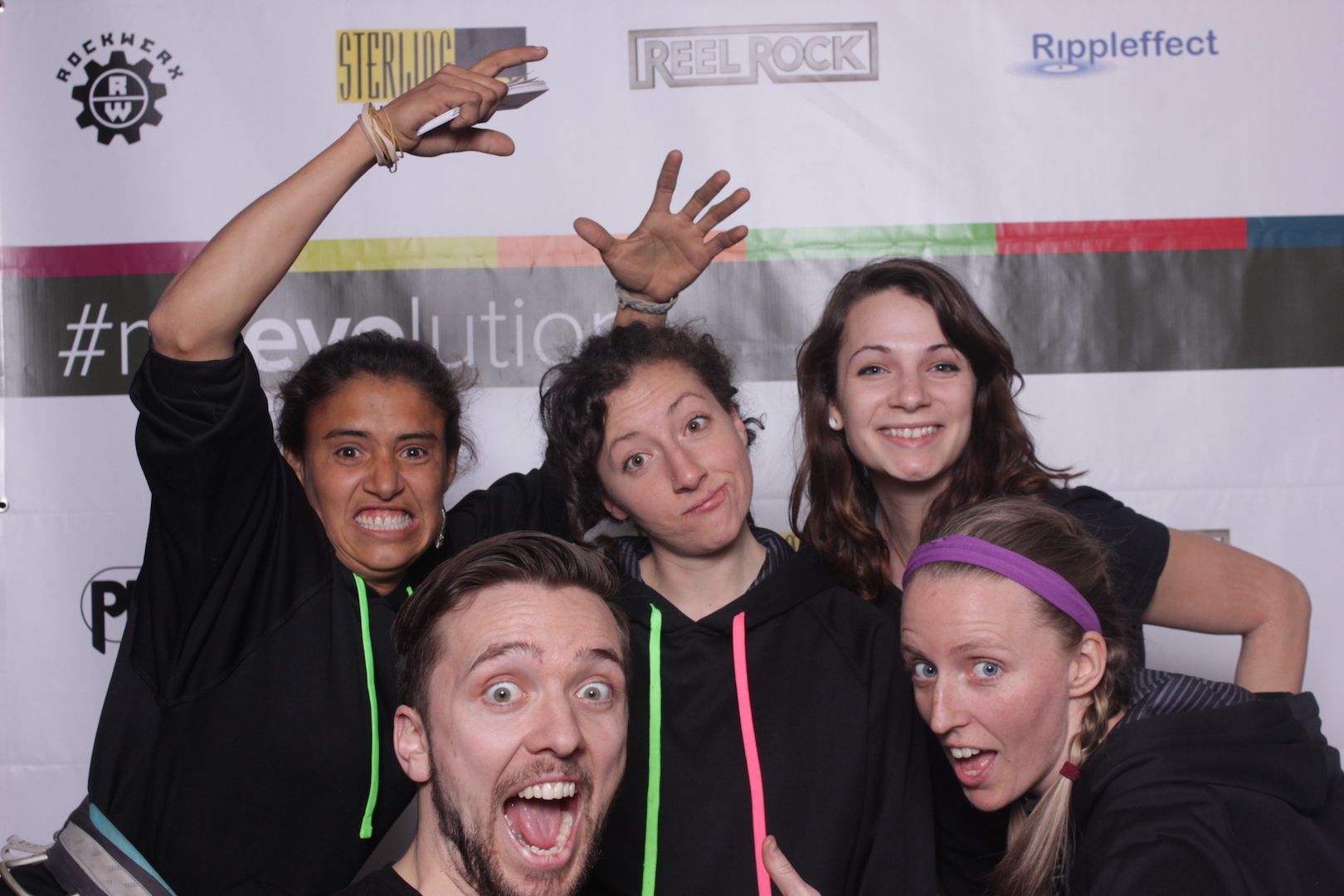 posing in front of a branded backdrop 20