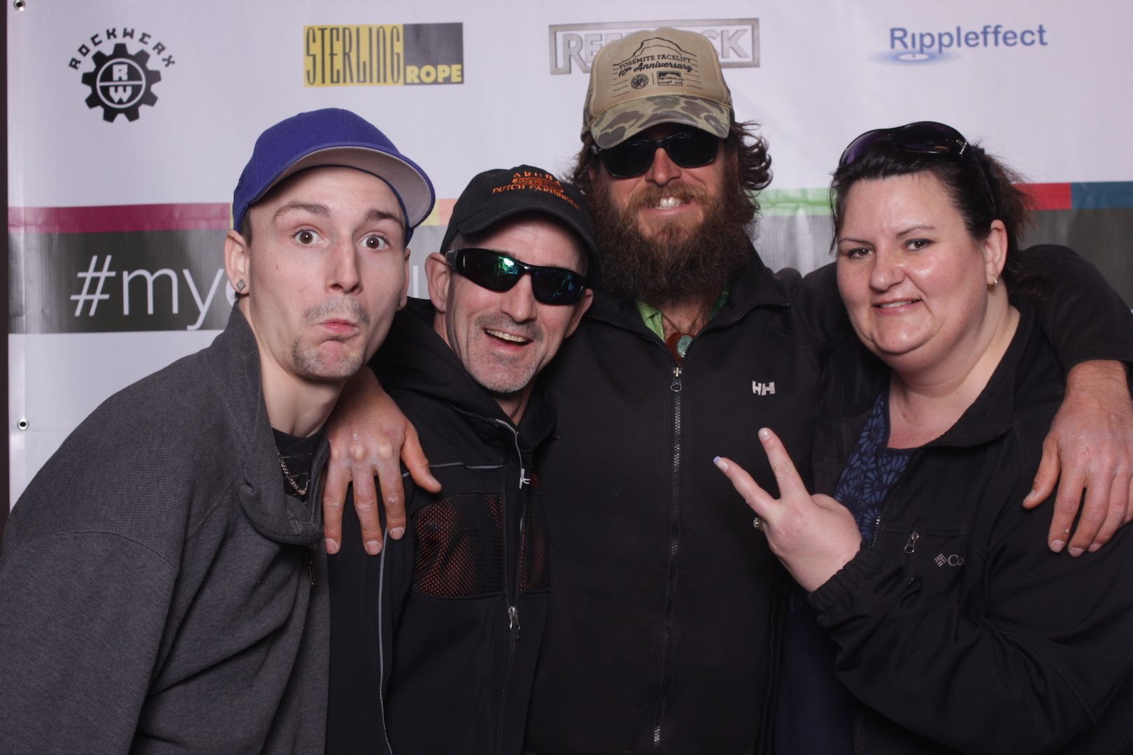 posing in front of a branded backdrop 21