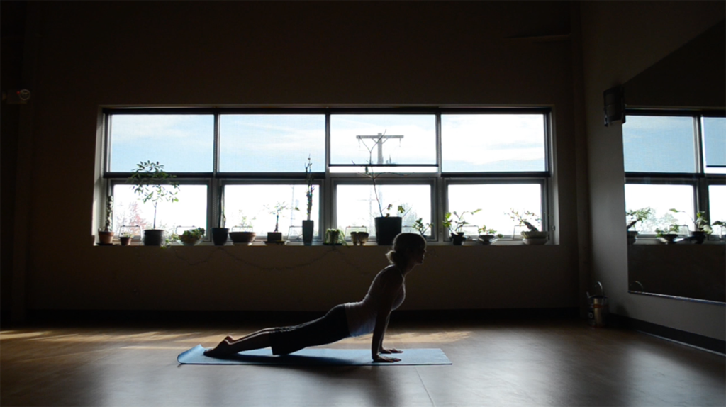 Two people watching a person climb 