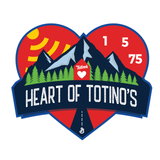 Heart of Totino’s 1975 logo with mountains, sun, trees, and red heart badge