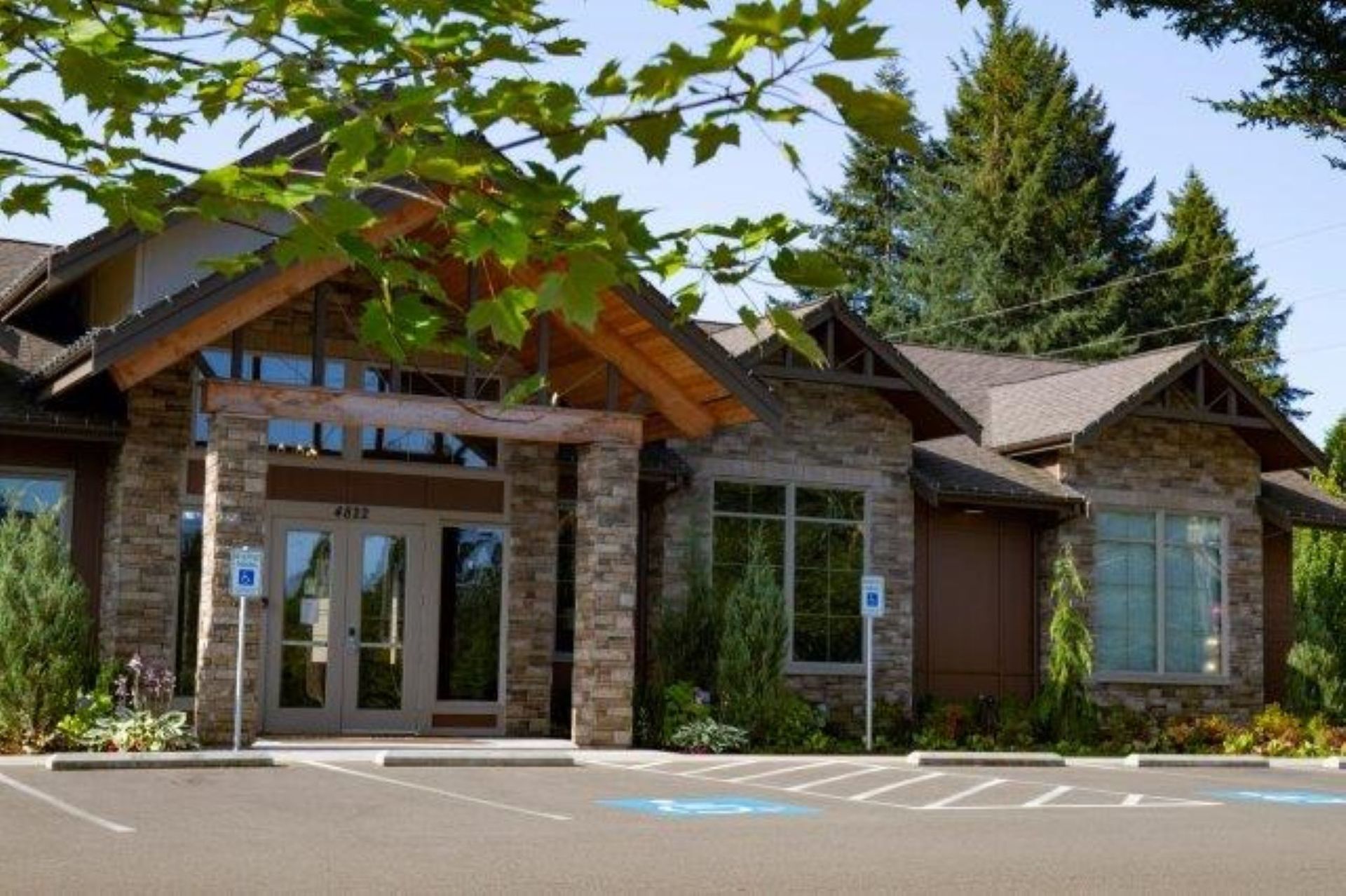 A large stone building with a parking lot in front of it