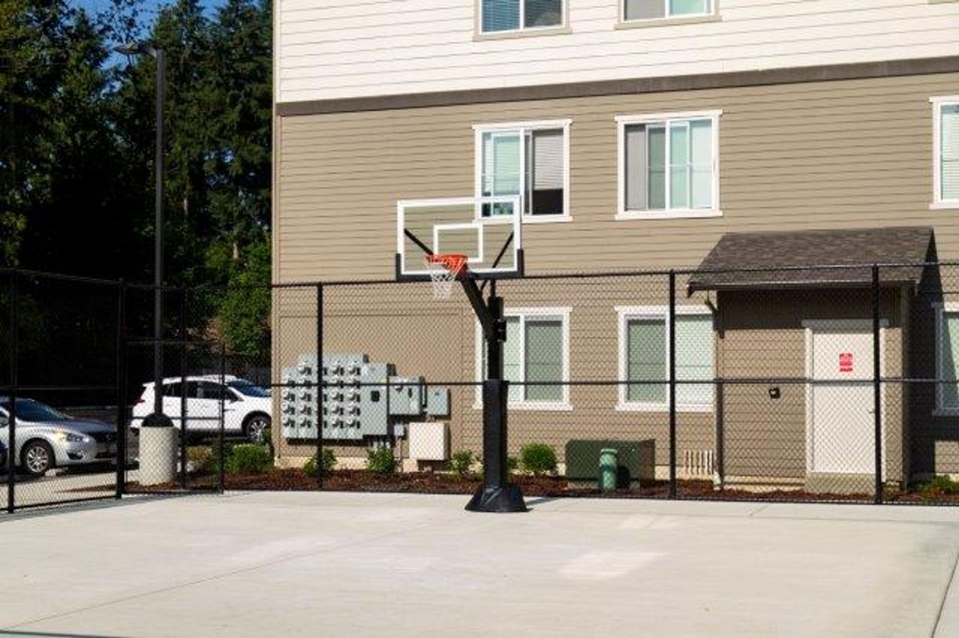 A basketball hoop is in front of a building