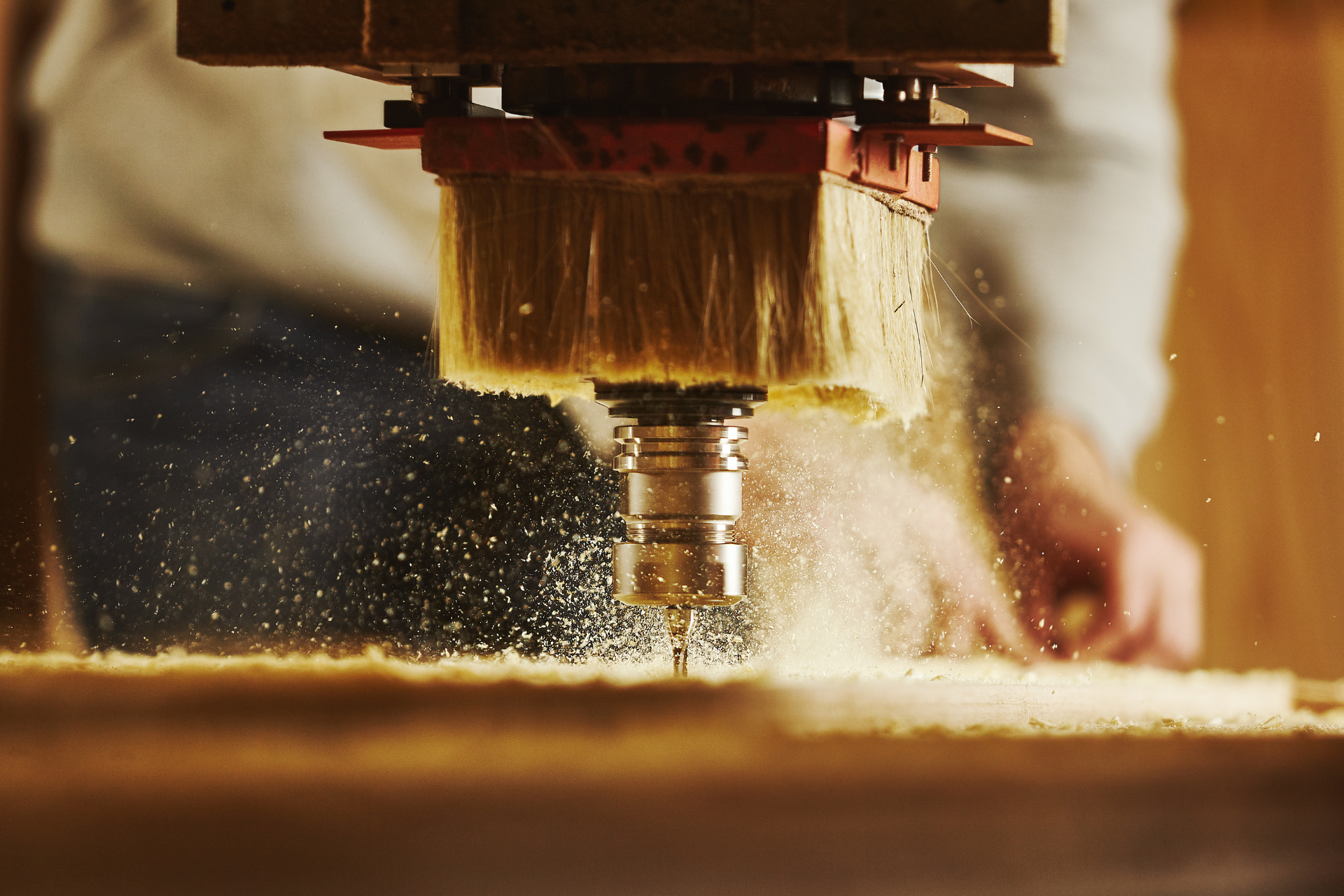 A person is using a machine to cut a piece of wood.
