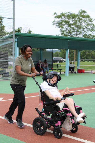 A group of people in wheelchairs are posing for a picture.
