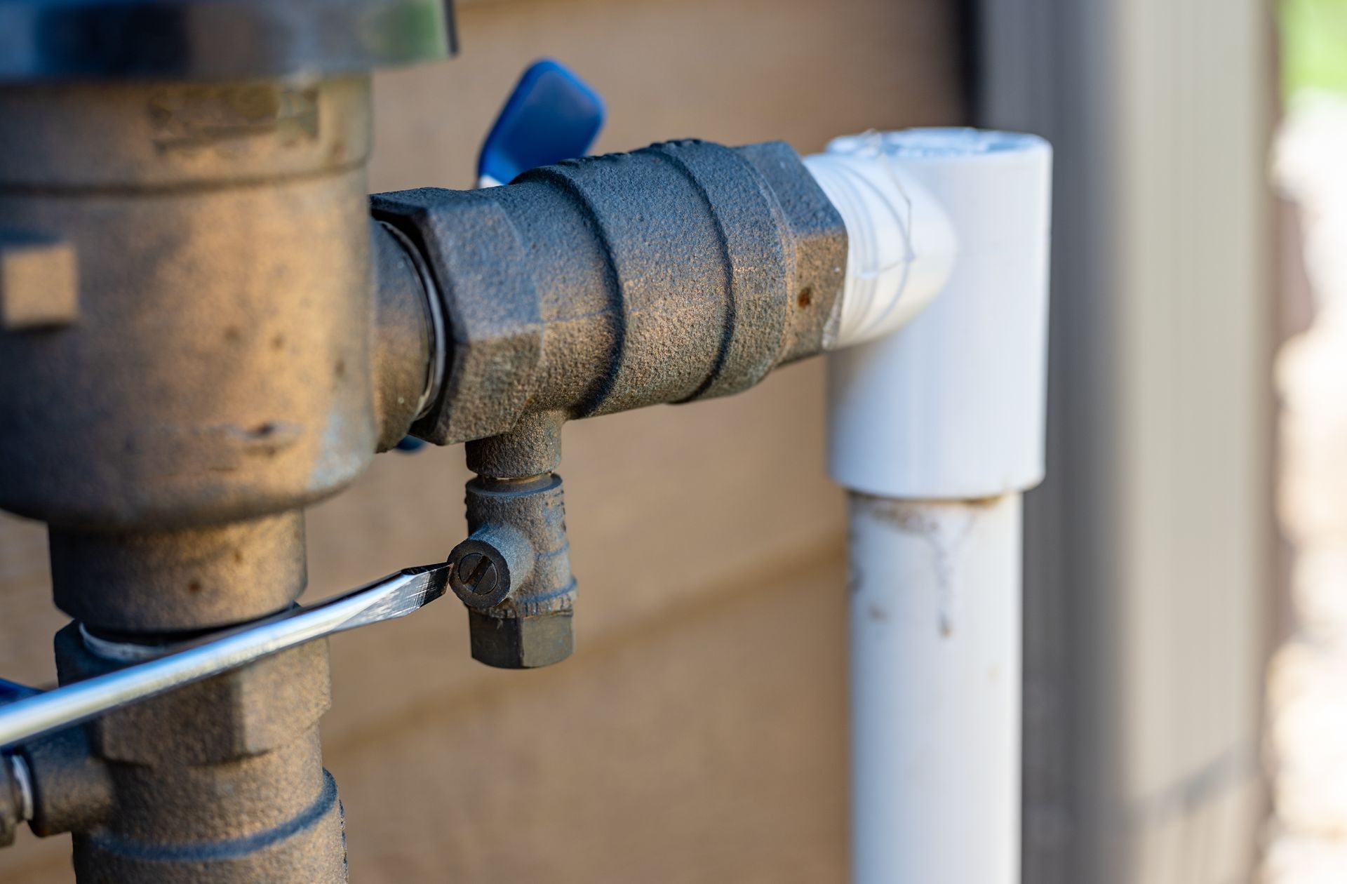 A close up of a pipe with a wrench attached to it.