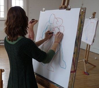 Nude male model posing for life drawing art class