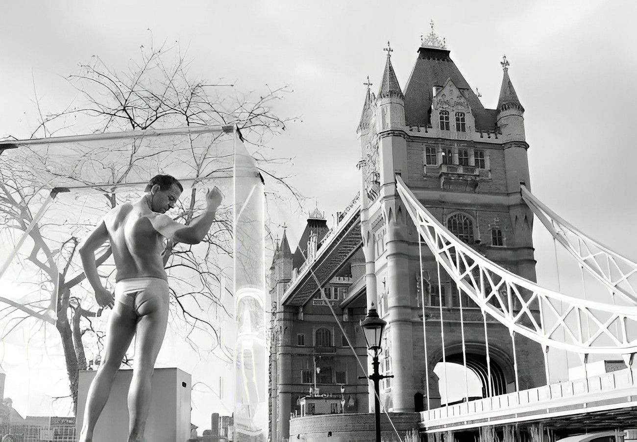 Mature male life model posing nude by Tower Bridge in London