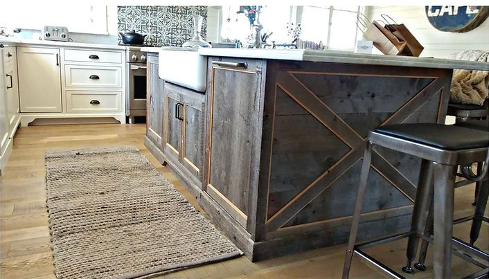 Rustic kitchen island with a farmhouse sink and two metal stools.