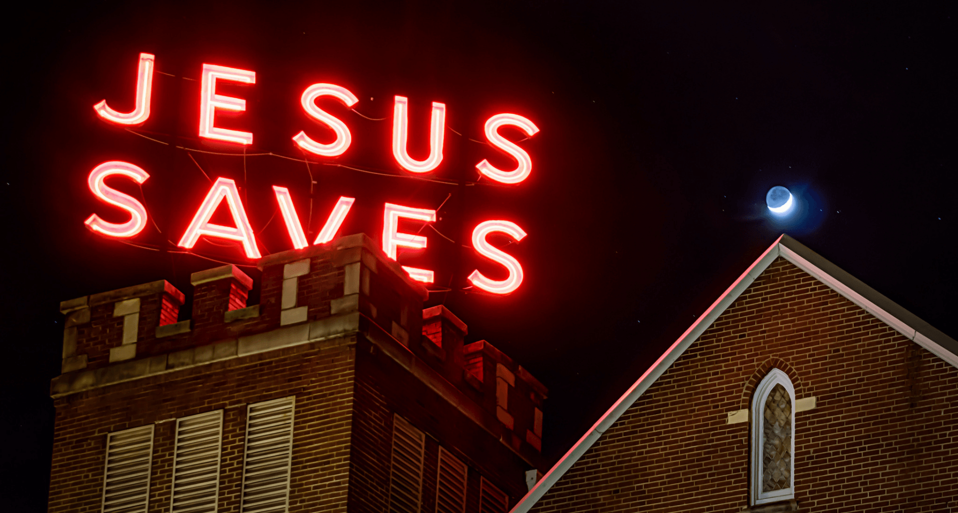 Neon sign on top of church that says