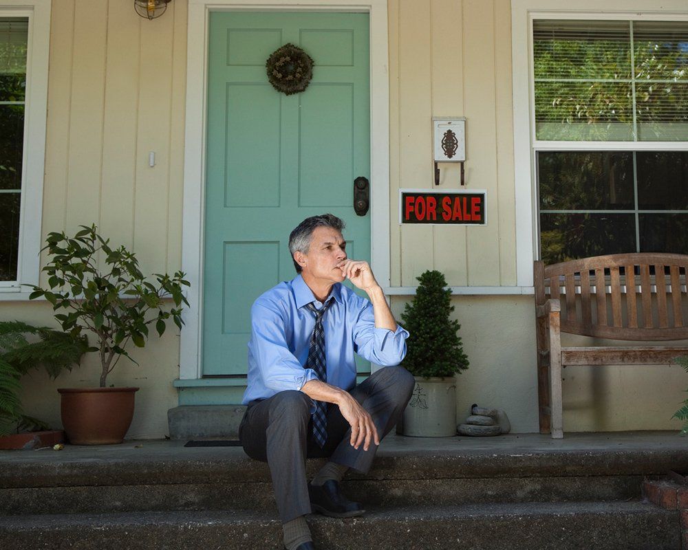 Man Sitting on Doorstep — Clinton Township, MI — Gigliotti & Associates, PC