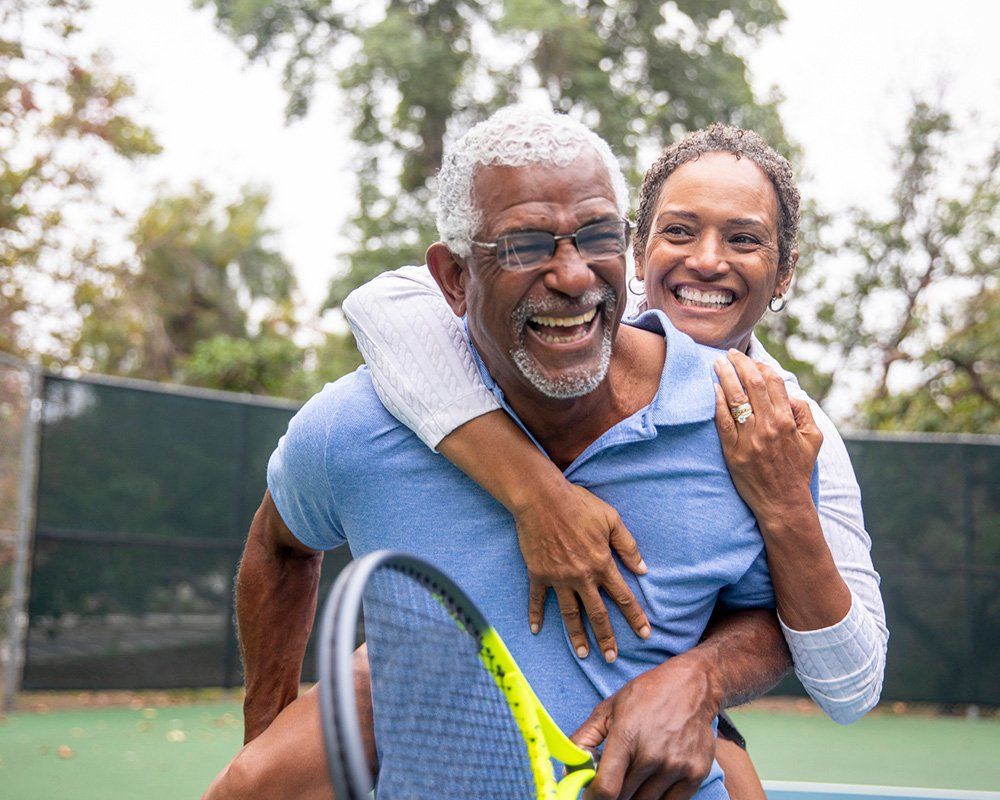 Black Couple on Tennis Court — Clinton Township, MI — Gigliotti & Associates, PC