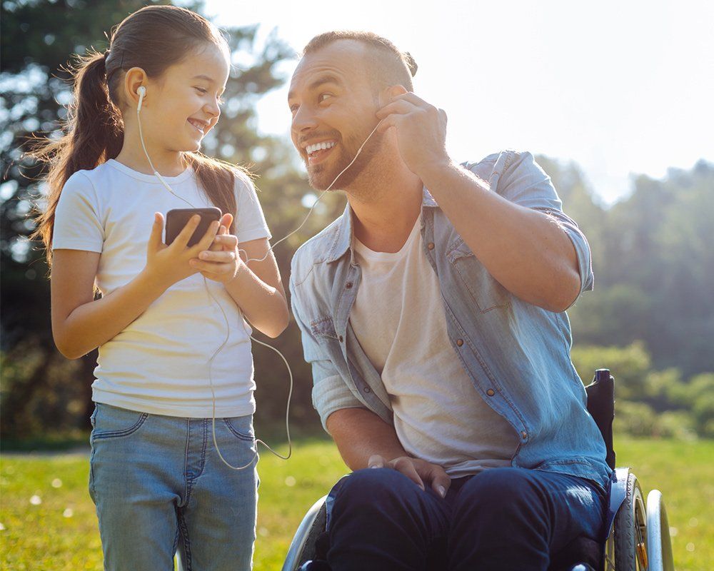 Daughter and Father with Disability Listening to Music — Clinton Township, MI — Gigliotti & Associates, PC