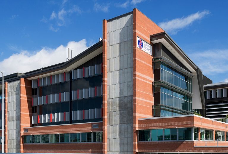 A large brick building with a blue sign on the side