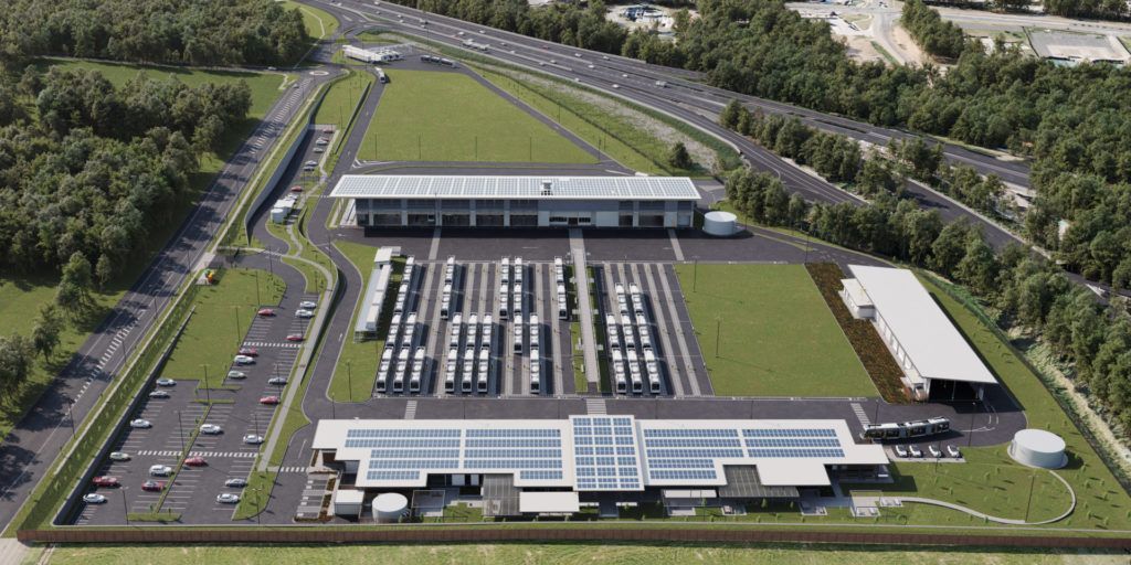 An aerial view of a large building with solar panels on the roof.