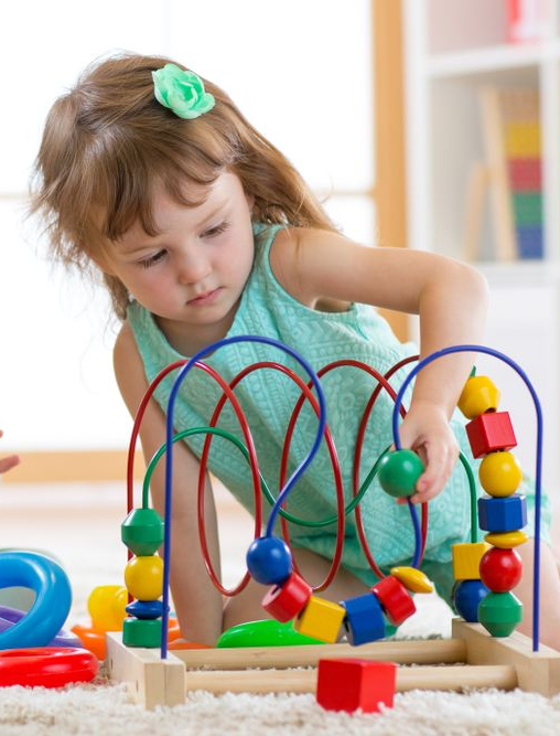 Young Girl Playing With a Colorful Bead Maze — Five Star Family Day Care in Singleton, NSW