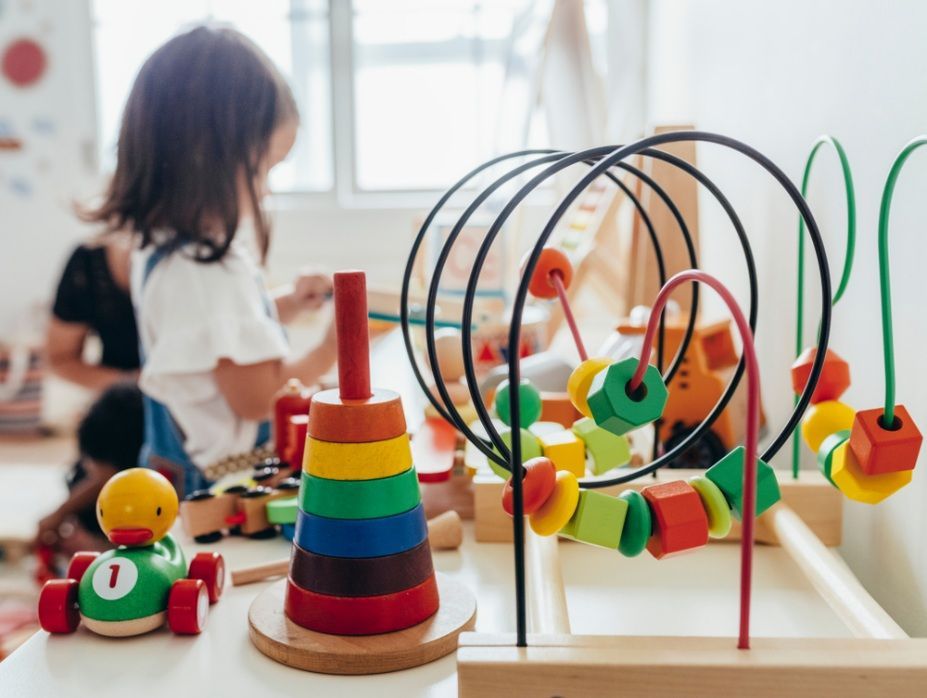 Child Playing With Wooden Toys at a Table — Five Star Family Day Care in Cessnock, NSW