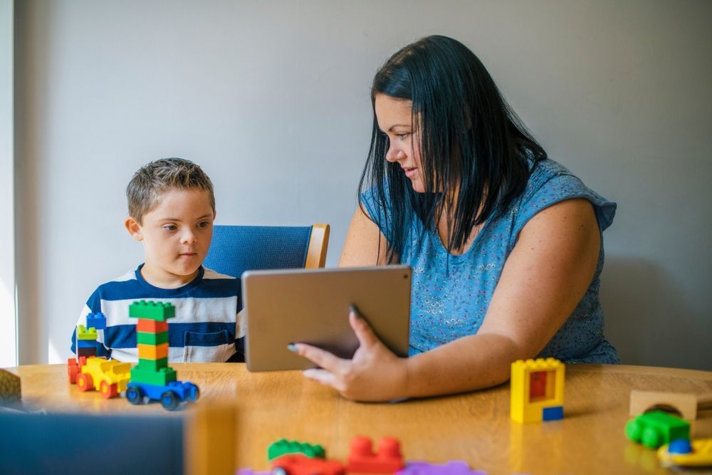 Woman and Young Boy Looking at a Tablet  — Five Star Family Day Care in Port Stephens, NSW