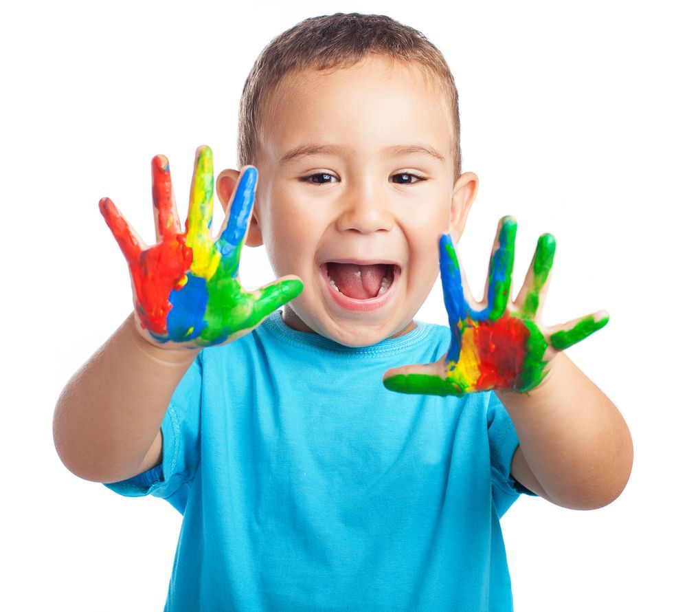 Young Child With Hands Covered in Colorful Paint, Smiling — Five Star Family Day Care in Singleton, NSW