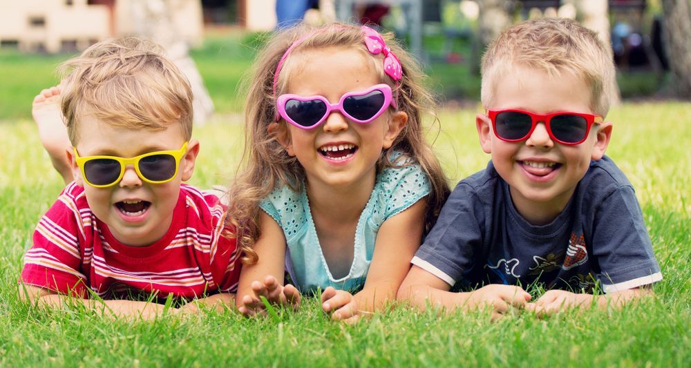 Three Young Children Smiling and Wearing Sunglasses — Five Star Family Day Care in Maitland, NSW