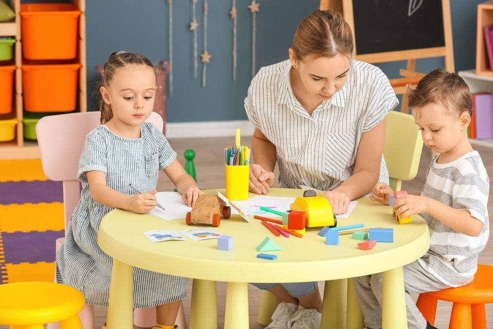 Children in a Classroom Playing Musical Instruments With a Teacher — Five Star Family Day Care in Metford, NSW