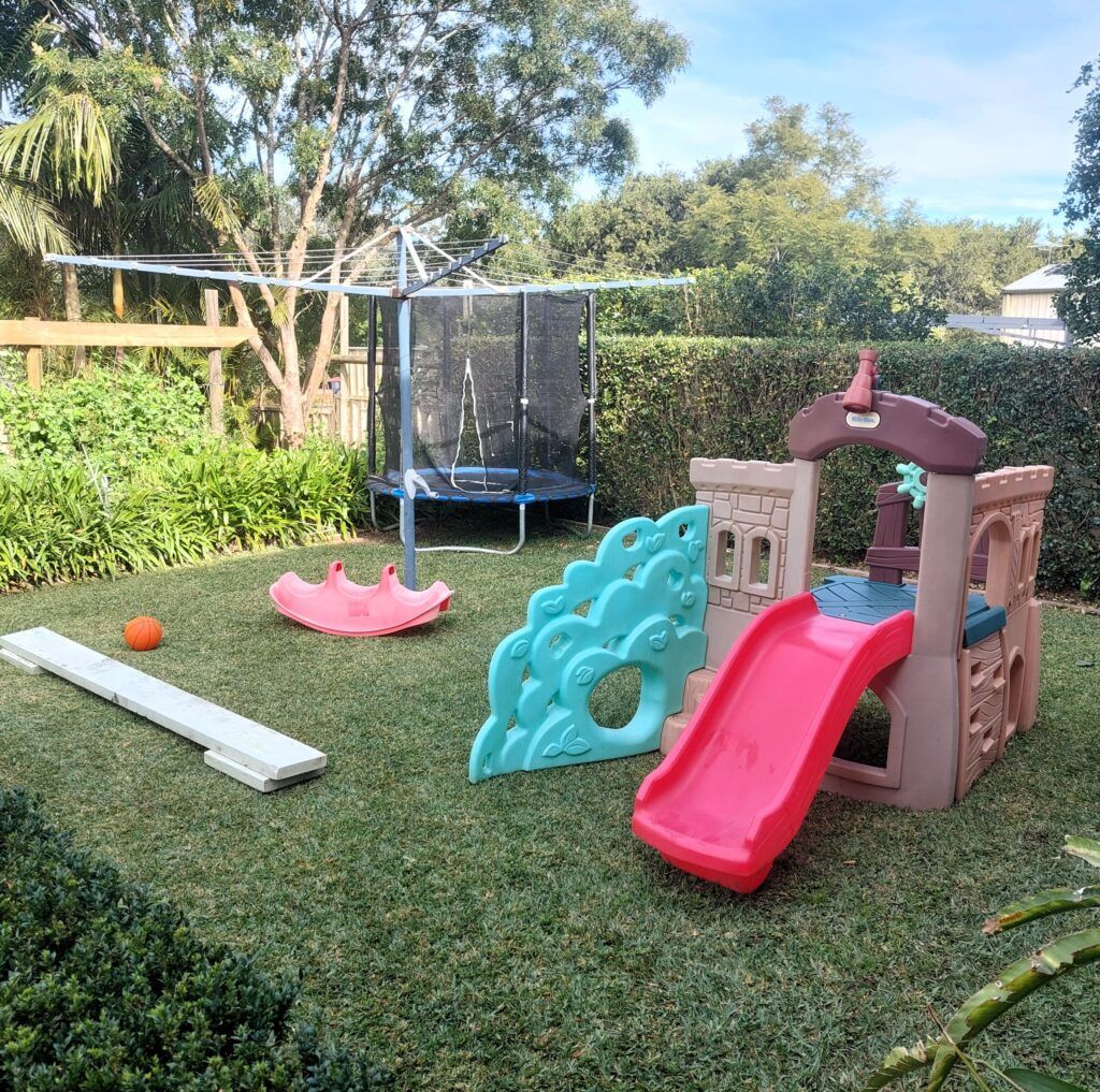 Backyard Playground with A Slide, Trampoline, Seesaw, and Balance Beam — Five Star Family Day Care in Maitland, NSW
