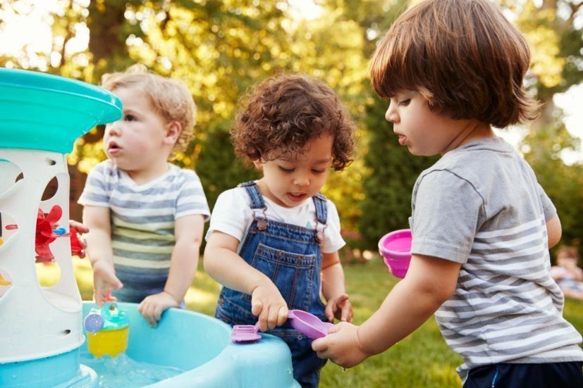 Three Toddlers Playing With a Water Table in an Outdoor Setting — Five Star Family Day Care In Muswellbrook, NSW