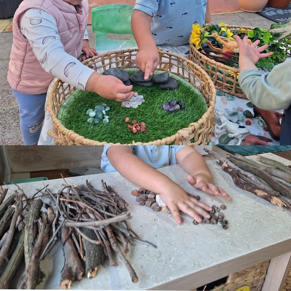 Two Children Are Playing With Rocks and Branches on a Table — Five Star Family Day Care in Maitland, NSW