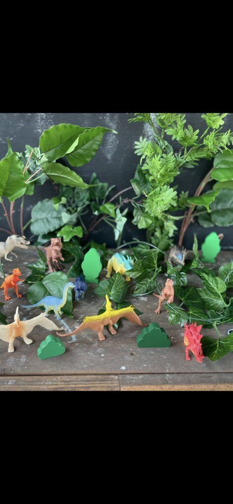 Toy Dinosaurs in a Forest Setting Made of Leaves and Plants — Five Star Family Day Care In Muswellbrook, NSW