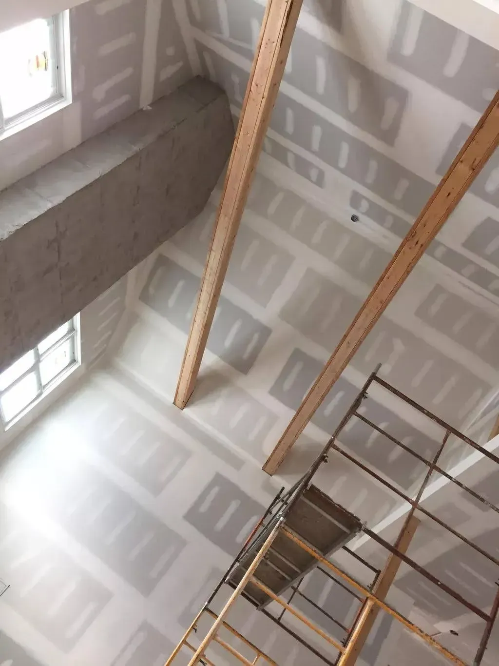 Interior view of a tall room undergoing drywall repair in Portsmouth, VA.