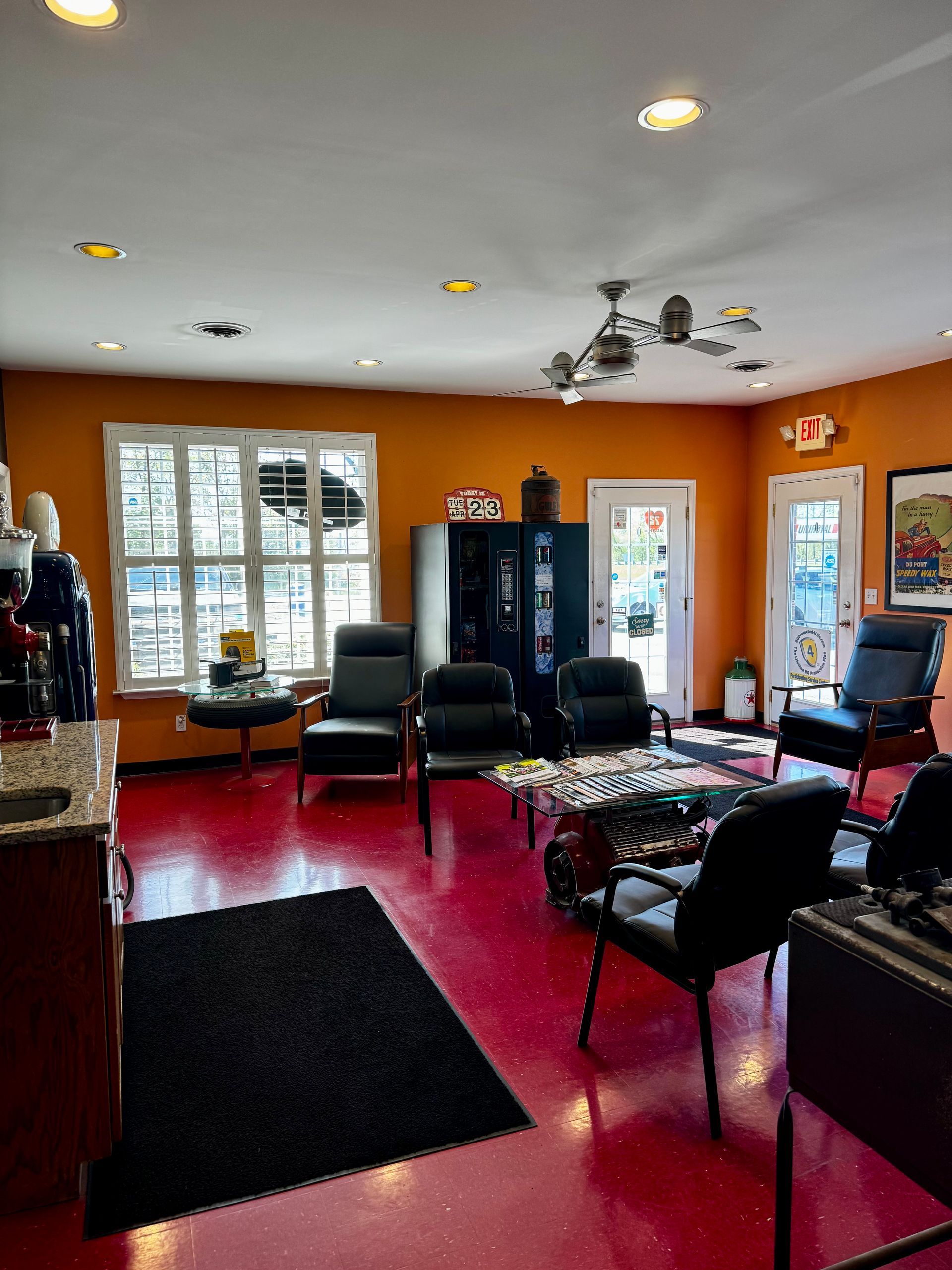 A waiting room with red floors and orange walls