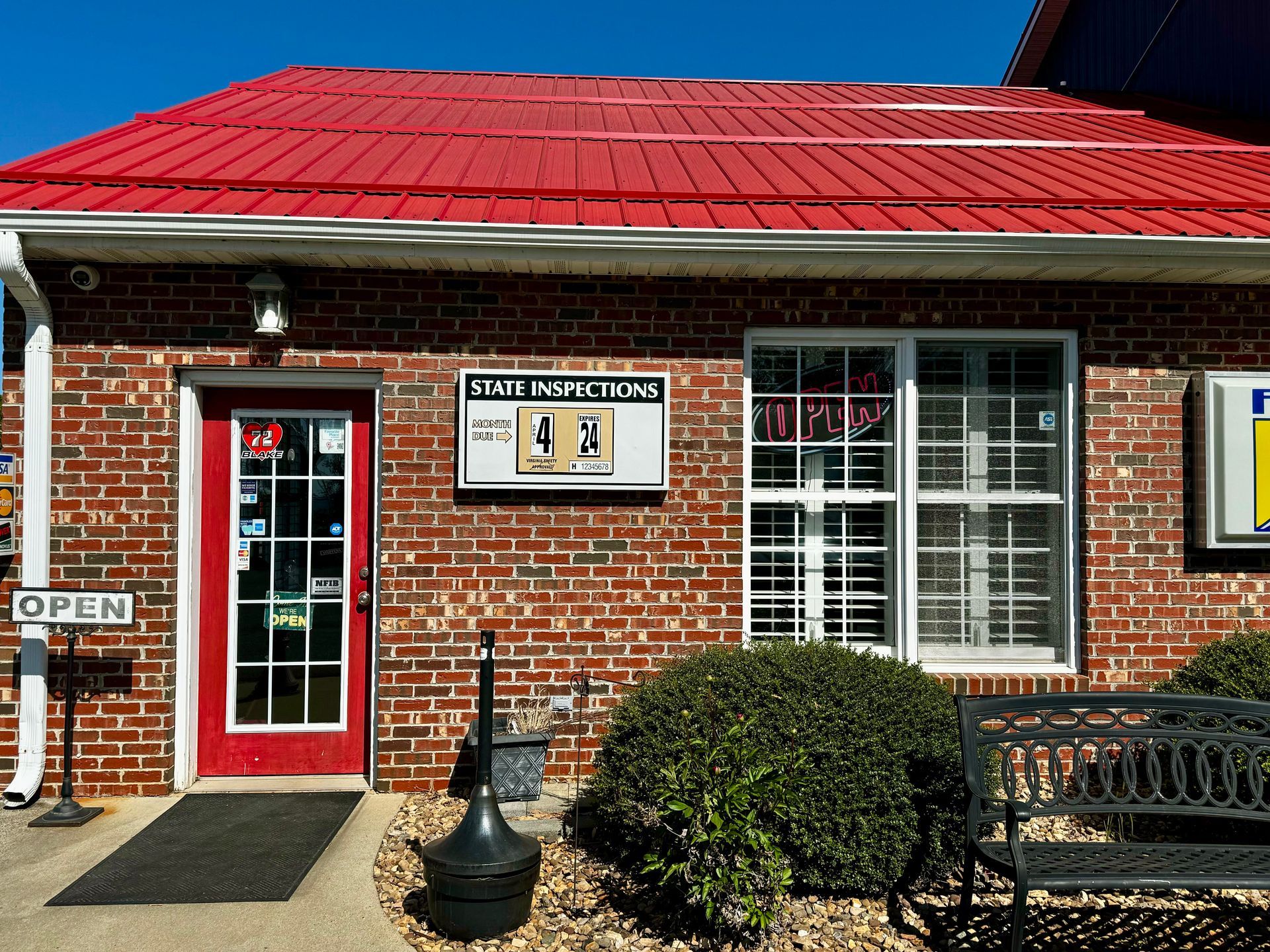 A brick building with a red roof and a sign that says open | Ruckersville, VA | KEL-CAM Tire & Auto