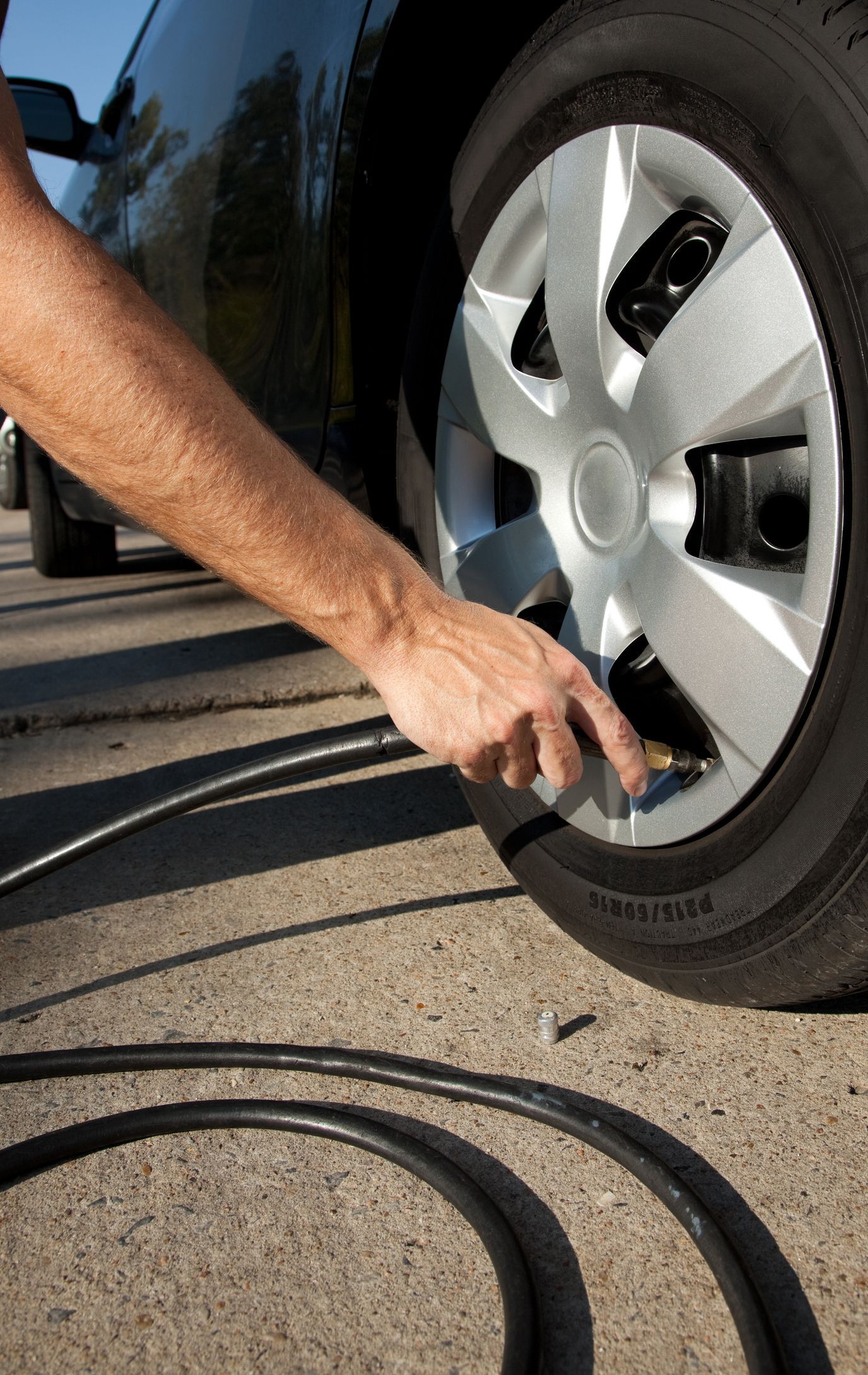 A person is pumping air into a car tire | Ruckersville, VA | KEL-CAM Tire & Auto