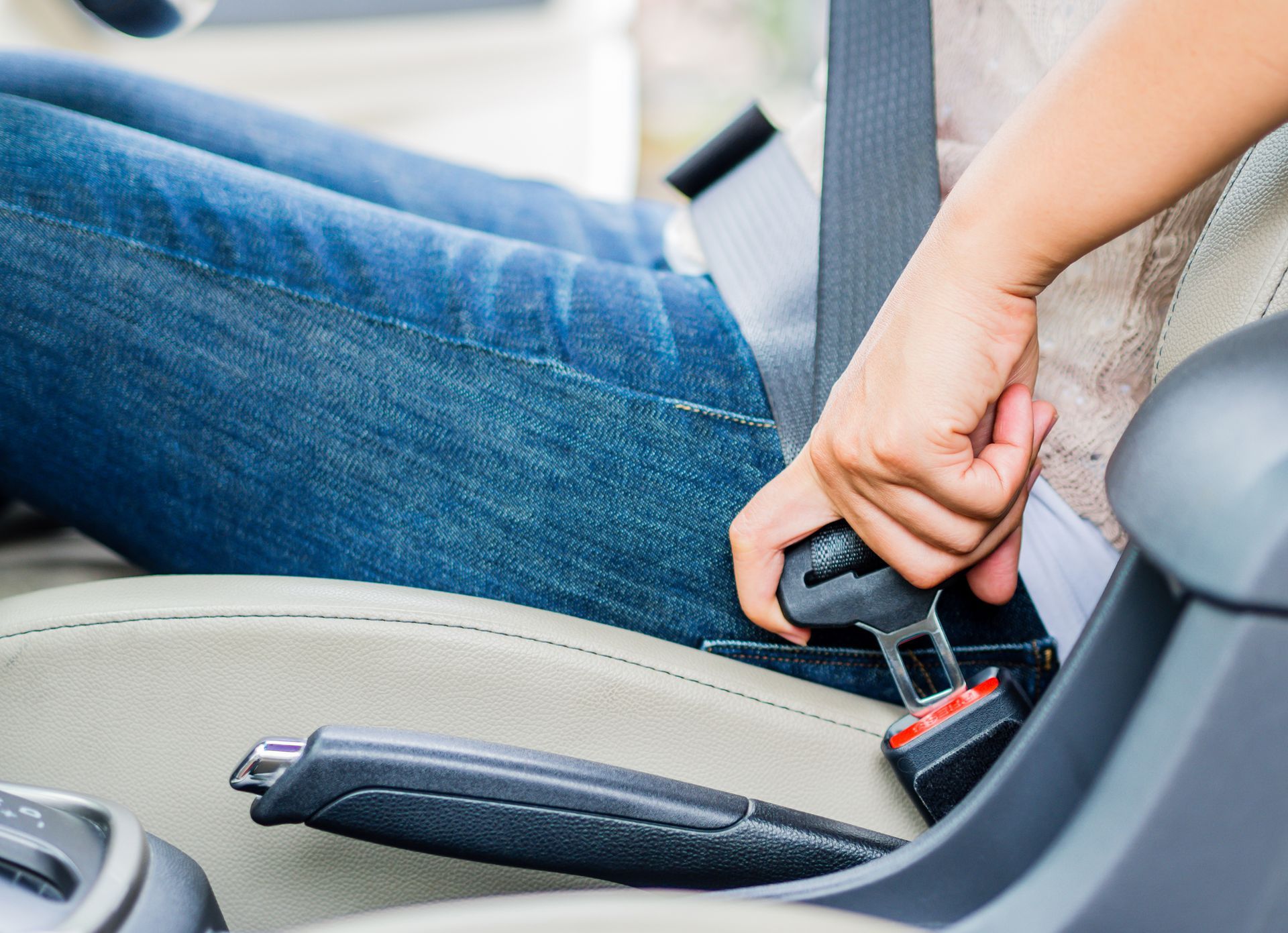 A person is putting on a seat belt in a car.| Ruckersville, VA | KEL-CAM Tire & Auto
